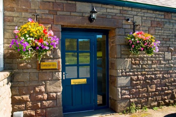 Flowers in hanging baskets at the estate office